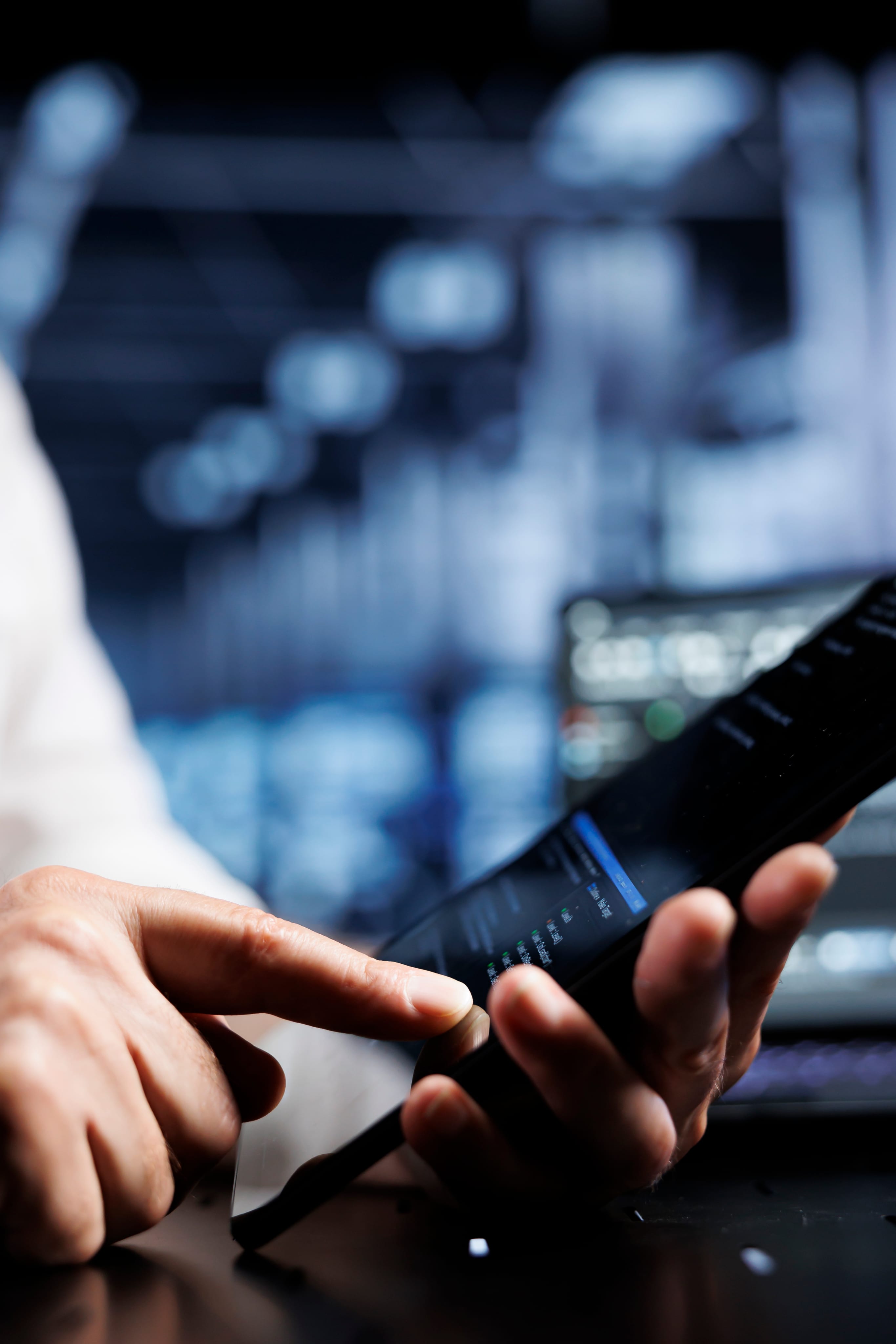 Professional reviewing financial data on a smartphone